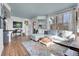 Bright living room featuring a plush sectional, colorful rug, and scenic views from large windows at 3000 E 16Th Ave # 320, Denver, CO 80206