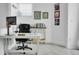 Bright home office with white walls, gray carpet, a blue ceiling, and a white desk at 3000 E 16Th Ave # 320, Denver, CO 80206