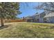Expansive backyard featuring a well-maintained lawn, mature trees, and privacy fencing at 7208 S Xanthia Way, Centennial, CO 80112