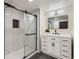 Modern bathroom with a glass-enclosed shower and sleek vanity with black hardware at 7208 S Xanthia Way, Centennial, CO 80112