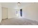 A simple bedroom with carpet and natural light through a window, adjacent to the modern black-trimmed door at 7208 S Xanthia Way, Centennial, CO 80112