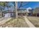 Charming two-story home with a brick and blue siding exterior and a well-maintained front yard at 7208 S Xanthia Way, Centennial, CO 80112