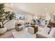 Spacious living room with a bright window, hardwood floors, and a bar that opens up to the kitchen at 7208 S Xanthia Way, Centennial, CO 80112