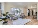 Bright living room featuring a large window, hardwood floors, and elegant decor at 7208 S Xanthia Way, Centennial, CO 80112