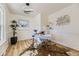 A bright office space showcases a modern desk, unique lighting, and stylish decor with a beautiful hardwood floor at 7208 S Xanthia Way, Centennial, CO 80112