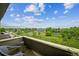 The balcony view features the neighborhood, lush greenery, mountains and beautiful partly cloudy blue skies at 3240 Iris Ave # G409, Boulder, CO 80301