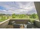View from balcony showing a landscape with trees and a building in the distance at 3240 Iris Ave # G409, Boulder, CO 80301