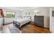 Sunlit bedroom featuring a large window, modern ceiling fan, and matching dressers at 3240 Iris Ave # G409, Boulder, CO 80301