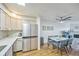 Open kitchen and dining area with stainless steel appliances and wood floors at 3240 Iris Ave # G409, Boulder, CO 80301