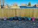 Backyard of a home with a wood fence and assorted flower pots and planters at 4558 S Laredo St, Aurora, CO 80015