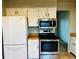 Bright kitchen features a white refrigerator and stainless steel stove and microwave at 4558 S Laredo St, Aurora, CO 80015