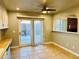 Bright breakfast nook with tile floors, a sliding door to the backyard and a pass-through to the kitchen at 4558 S Laredo St, Aurora, CO 80015