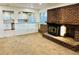 Living Room with brick fireplace opens to the kitchen, featuring light countertops and stainless steel appliances at 4558 S Laredo St, Aurora, CO 80015