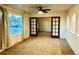 Living Room with ceiling fan, large window with curtains and wood-framed french doors to another room at 4558 S Laredo St, Aurora, CO 80015