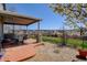 Backyard featuring a patio, grassy area, wooden fence, and views of houses in the distance at 952 Eaglestone Dr, Castle Rock, CO 80104