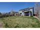 Expansive backyard with a covered patio, solar panels, and ample green space, perfect for outdoor entertaining at 952 Eaglestone Dr, Castle Rock, CO 80104