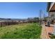 Spacious grassy backyard with a wood fence and views of the hills, perfect for outdoor activities at 952 Eaglestone Dr, Castle Rock, CO 80104
