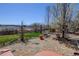 Scenic backyard featuring a brick patio, grass, and trees with lovely views of the surrounding landscape at 952 Eaglestone Dr, Castle Rock, CO 80104