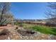 Serene backyard featuring a stone patio, lush lawn, and tasteful landscaping at 952 Eaglestone Dr, Castle Rock, CO 80104