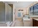 Well-lit bathroom featuring walk-in shower, soaking tub, and tiled floor at 952 Eaglestone Dr, Castle Rock, CO 80104