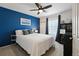 Stylish bedroom with a blue accent wall, ceiling fan, and comfortable bed with decorative pillows at 952 Eaglestone Dr, Castle Rock, CO 80104