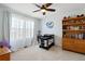 Bright bedroom with large windows, ceiling fan, and a changing table next to a wooden dresser at 952 Eaglestone Dr, Castle Rock, CO 80104
