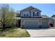 Charming two-story home with a three-car garage, well-manicured lawn, and mature trees at 952 Eaglestone Dr, Castle Rock, CO 80104