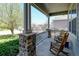 Inviting front porch with stone pillars, rocking chairs, and a view of the neighborhood at 952 Eaglestone Dr, Castle Rock, CO 80104