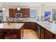 Kitchen with granite countertops, wood cabinets, stainless steel appliances, and sink by window at 952 Eaglestone Dr, Castle Rock, CO 80104