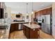 Kitchen with granite counters, stainless appliances, wood cabinets, and view into living room at 952 Eaglestone Dr, Castle Rock, CO 80104