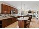 Open kitchen with wood cabinets, granite countertops, stainless steel appliances, and view to living room at 952 Eaglestone Dr, Castle Rock, CO 80104