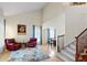 Bright living room with vaulted ceilings, hardwood floors, and staircase access at 952 Eaglestone Dr, Castle Rock, CO 80104
