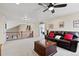 Inviting upstairs living room features neutral carpet, ceiling fan, and comfortable seating area at 952 Eaglestone Dr, Castle Rock, CO 80104