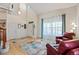Bright living room featuring hardwood floors, high ceilings, large windows, and comfortable seating at 952 Eaglestone Dr, Castle Rock, CO 80104