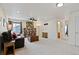 Spacious living room with large windows, wall to wall carpet, and ceiling fan at 952 Eaglestone Dr, Castle Rock, CO 80104