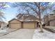 Inviting townhome with stone accents and an attached two-car garage, perfect for easy access and extra storage space at 439 W 91St Cir, Thornton, CO 80260