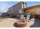 Backyard with a brick fire pit and covered patio great for entertaining at 12092 S Great Plain Ct, Parker, CO 80134