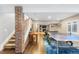 Finished basement featuring a recreation area, brick accent wall, and ample space for entertainment at 12092 S Great Plain Ct, Parker, CO 80134