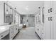 Bright bathroom featuring dual vanities and a glass enclosed walk-in shower and soaking tub at 12092 S Great Plain Ct, Parker, CO 80134