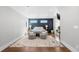 A bedroom with a gray accent wall, a comfy bed, chairs and large decorative rug on hardwood floors at 12092 S Great Plain Ct, Parker, CO 80134