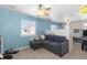 Upstairs bedroom featuring a comfortable couch and a view to the outside at 12092 S Great Plain Ct, Parker, CO 80134
