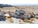 Stunning two-story gray home boasts an attached three-car garage and beautiful landscaping at 12092 S Great Plain Ct, Parker, CO 80134