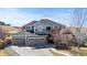 Beautiful two-story home featuring a three-car garage and well-manicured lawn at 12092 S Great Plain Ct, Parker, CO 80134