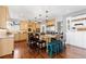 Bright and airy kitchen with custom cabinets, a large island, and modern pendant lighting at 12092 S Great Plain Ct, Parker, CO 80134