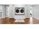 Convenient laundry room featuring side-by-side washer and dryer with white cabinets and drawers at 12092 S Great Plain Ct, Parker, CO 80134