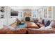 Inviting living room with a stone fireplace, plush seating, and bright natural light at 12092 S Great Plain Ct, Parker, CO 80134
