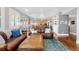 Spacious living room with hardwood floors, a leather sofa, and an open floor plan at 12092 S Great Plain Ct, Parker, CO 80134