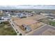 Aerial view of horse property featuring a large arena, stables, and pasture at 16122 Emporia Way, Brighton, CO 80602