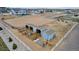 Aerial view of equestrian property featuring a barn, stalls, and riding arena at 16122 Emporia Way, Brighton, CO 80602