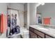 Bathroom features a granite-topped vanity, a bathtub with a horse-themed shower curtain, and neutral tile at 16122 Emporia Way, Brighton, CO 80602